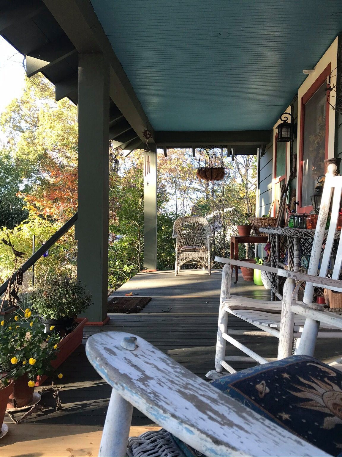 A welcoming Appalachian porch surrounded by garden greenery